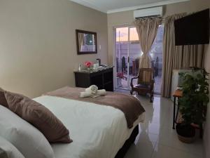 a bedroom with a bed with a towel on it at Addo River Den in Gqeberha