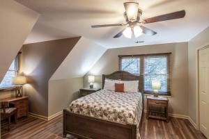a bedroom with a bed and a ceiling fan at Nestled Inn in Townsend