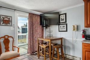 a kitchen with a table and a balcony at ML 345 Ski-InOut Slope Views Sleeps 6 Steps to Ballhooter in Snowshoe