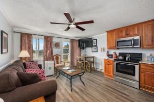 a living room with a couch and a ceiling fan at ML 345 Ski-InOut Slope Views Sleeps 6 Steps to Ballhooter in Snowshoe