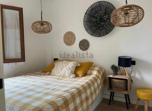 a bedroom with a bed and a fan on the wall at Chalet Las Meninas in Denia +12 photos