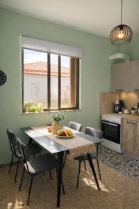 a kitchen with a table with a bowl of fruit on it at The Citrus Yard in Politika, 2 bedrooms apartment in Politika
