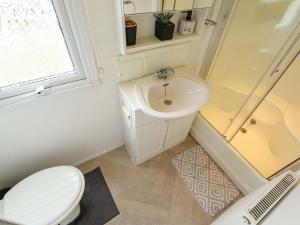 a bathroom with a toilet and a sink at Towervans Z11 in Mablethorpe