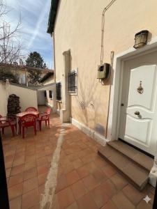 a patio with a table and chairs next to a building at La Morada del Jucar in Cuenca