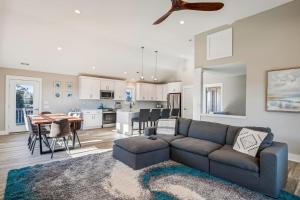 a living room and kitchen with a couch and a table at 4920 - Stress Less II in Kitty Hawk