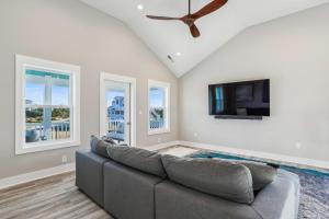 a living room with a couch and a flat screen tv at 4920 - Stress Less II in Kitty Hawk