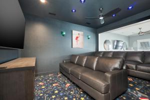 a living room with a couch and a flat screen tv at 5705 - Edgewater View in Nags Head