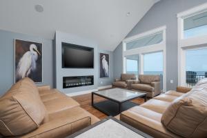 a living room with a couch and a tv at 5705 - Edgewater View in Nags Head