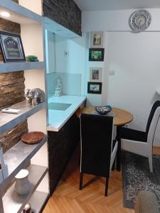 a dining room with a table and a chair at Dimitra Stan na dan in Šabac +24 photos