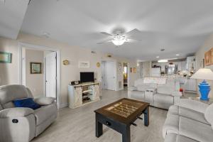 a living room with couches and a table at 7081 - Sea View in Rodanthe
