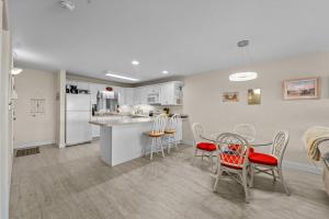 a kitchen and dining room with a table and chairs at 7081 - Sea View in Rodanthe +19 photos