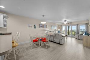 a kitchen and living room with a table and chairs at 7081 - Sea View in Rodanthe