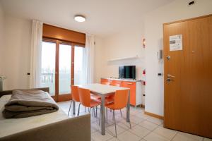 a room with a bed and a table and chairs at Residence Roberta - Agenzia Arcobaleno in Caorle