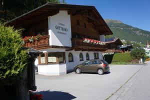 samochód zaparkowany na parkingu przed budynkiem w obiekcie Landhaus Gotthard w Solden