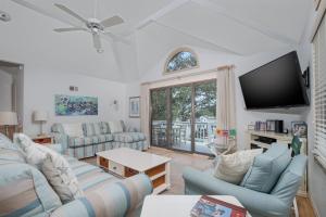 a living room with couches and a flat screen tv at 4603 - Yellow Brick Road in Southern Shores