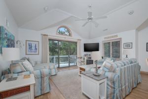 a living room with couches and a tv at 4603 - Yellow Brick Road in Southern Shores