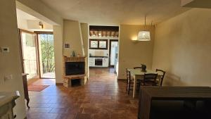 a kitchen and dining room with a table and a fireplace at Da Taz Siena in Siena