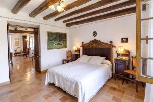 a bedroom with a bed and a table and chairs at Catalunya Casas Unique sanctuary with extra large pool! in Santa Oliva