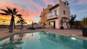 a swimming pool in front of a house at Apartamentos Calanegra con Piscina y Solárium en Puerto de Mazarrón Costa Cálida in Murcia
