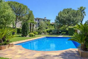 a swimming pool in a yard with trees and a building at Catalunya Casas Unique sanctuary with extra large pool! in Santa Oliva +42 photos