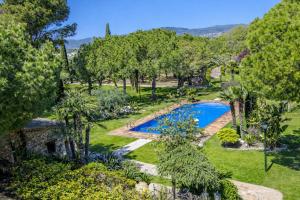 an aerial view of a garden with a swimming pool at Catalunya Casas Unique sanctuary with extra large pool! in Santa Oliva