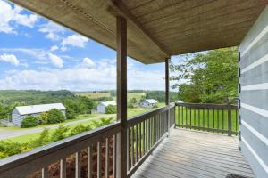 a view from the balcony of a home with a view at Hillside Hideout Log Cabin For 2! Cabin 10 in Fancy Gap