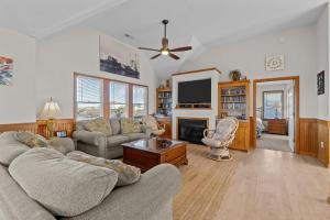 a living room with a couch and a tv at 7200 - Better Surf Than Sorry in Salvo