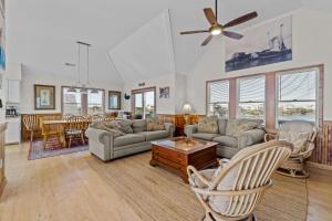 a living room with a couch and a table at 7200 - Better Surf Than Sorry in Salvo +44 photos