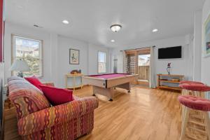 a living room with a couch and a pool table at 4744 - Sandy Beaches in Kitty Hawk Beach
