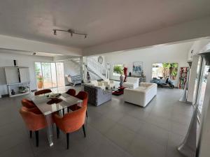 a living room with a table and chairs at Villa Joëlle in Anse Marcel 