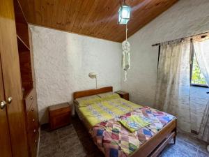 a bedroom with a bed in the corner of a room at La Pantera in San Antonio de Arredondo