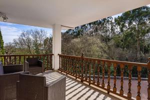 a porch with a view of the woods at Vivienda Vacacional La Seronda in Ribadesella