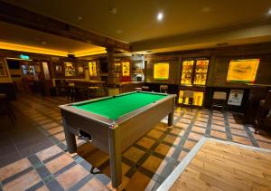 a pool table in a room with a pool table at Kerry Coast Hotel in Cahersiveen
