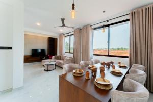 a living room with a table and chairs at Peak Heaven Apartments in Negombo