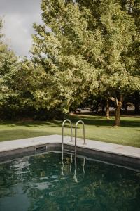 a swimming pool with two handles in the water at Hotel Bernat de So in Llivia