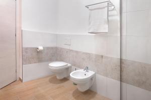 a bathroom with a toilet and a sink at Terra e Mare Apartments II- Terra in Sorso