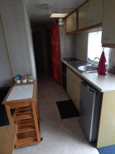 a small kitchen with a sink and a stove at L'ancyze in Le Torp-Mesnil