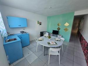 a small kitchen with a table and chairs in a room at Wilkan Hotel in Las Terrenas