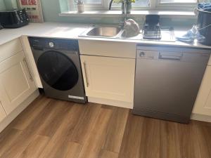 a kitchen with a sink and a dishwasher at High Tide in Whitstable +14 photos
