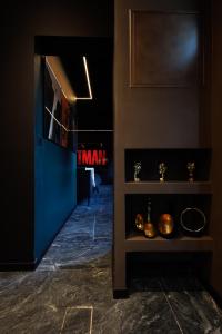 a room with a wall with a tv and a shelf at Suite Dark Luxe avec Écran géant de cinéma et jacuzzi in Clary +17 photos