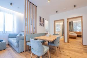 a living room with a table and a couch at Appartament Lago di Braies in San Sigismondo