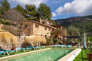 a villa with a swimming pool and a building at Villa My Love Mallorca in Bunyola