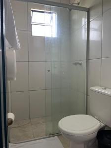 a bathroom with a toilet and a glass shower at Pousada do Rei in Sarzedo +15 photos