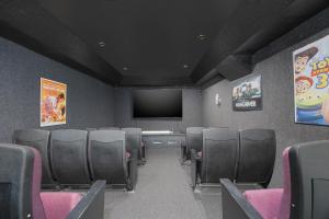 a conference room with chairs and a flat screen tv at 7158 - A Wave From It All in Waves