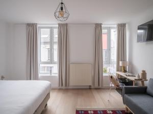 a bedroom with a bed and a couch and a desk at Suzan's Guesthouse in Ghent +17 photos