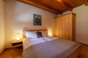 a bedroom with a large bed and a wooden cabinet at Heiligenhof in Laces +24 photos