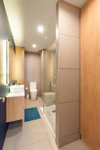 a bathroom with a toilet and a sink and a shower at VIVA Serpa Pinto Serviced Apartments in Porto +23 photos