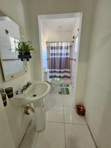 a white bathroom with a sink and a toilet at Wilkan Hotel in Las Terrenas +54 photos