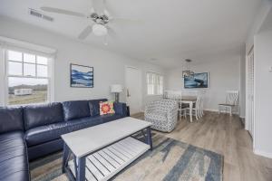 a living room with a couch and a table at 7766 - Striper in Buxton