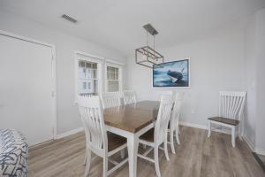 a dining room with a wooden table and chairs at 7766 - Striper in Buxton +26 photos